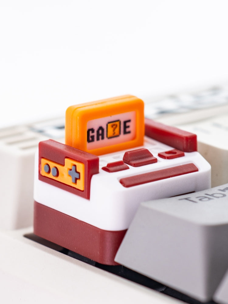 Red and white gaming consoles with personalized keycaps and replaceable cartridges. Multi color resin molding